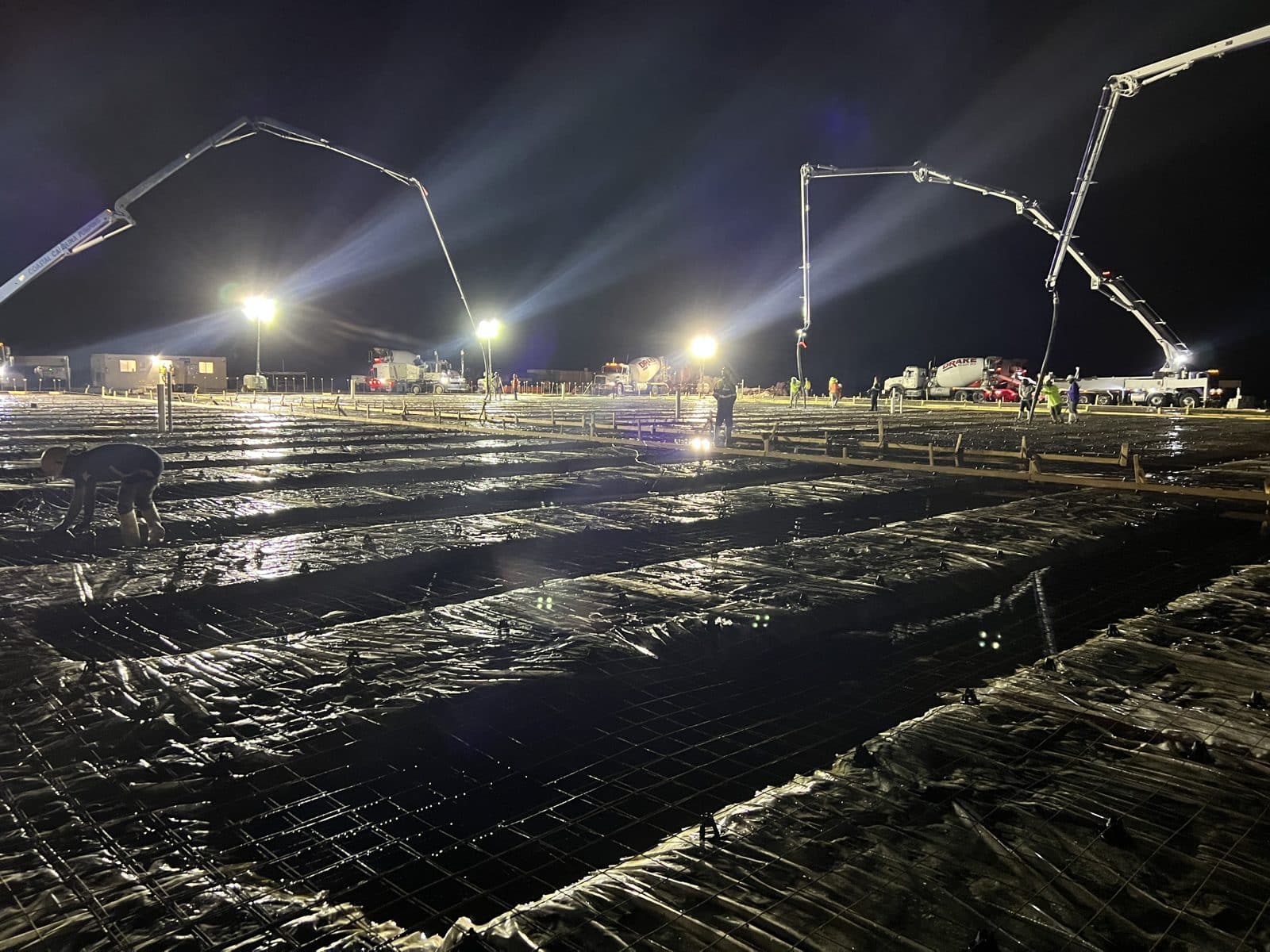 Rebar mat over vapor barrier staged for a night commercial slab pour