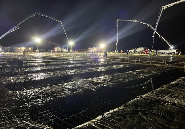 Rebar mat over vapor barrier staged for a night commercial slab pour